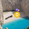 logo binance przy wraku statku na rafie