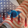 niebieskie logo bitcoina z czerwonymi strzałkami skierowanymi w dół na tle flagi usa