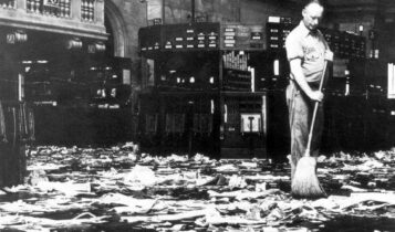 Pracownik sprząta bałagan na parkiecie giełdy po krachu 1929 roku