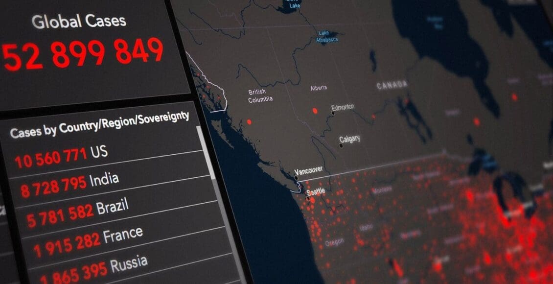 Licznik przypadków pandemii na smartfonie na tle mapy świata