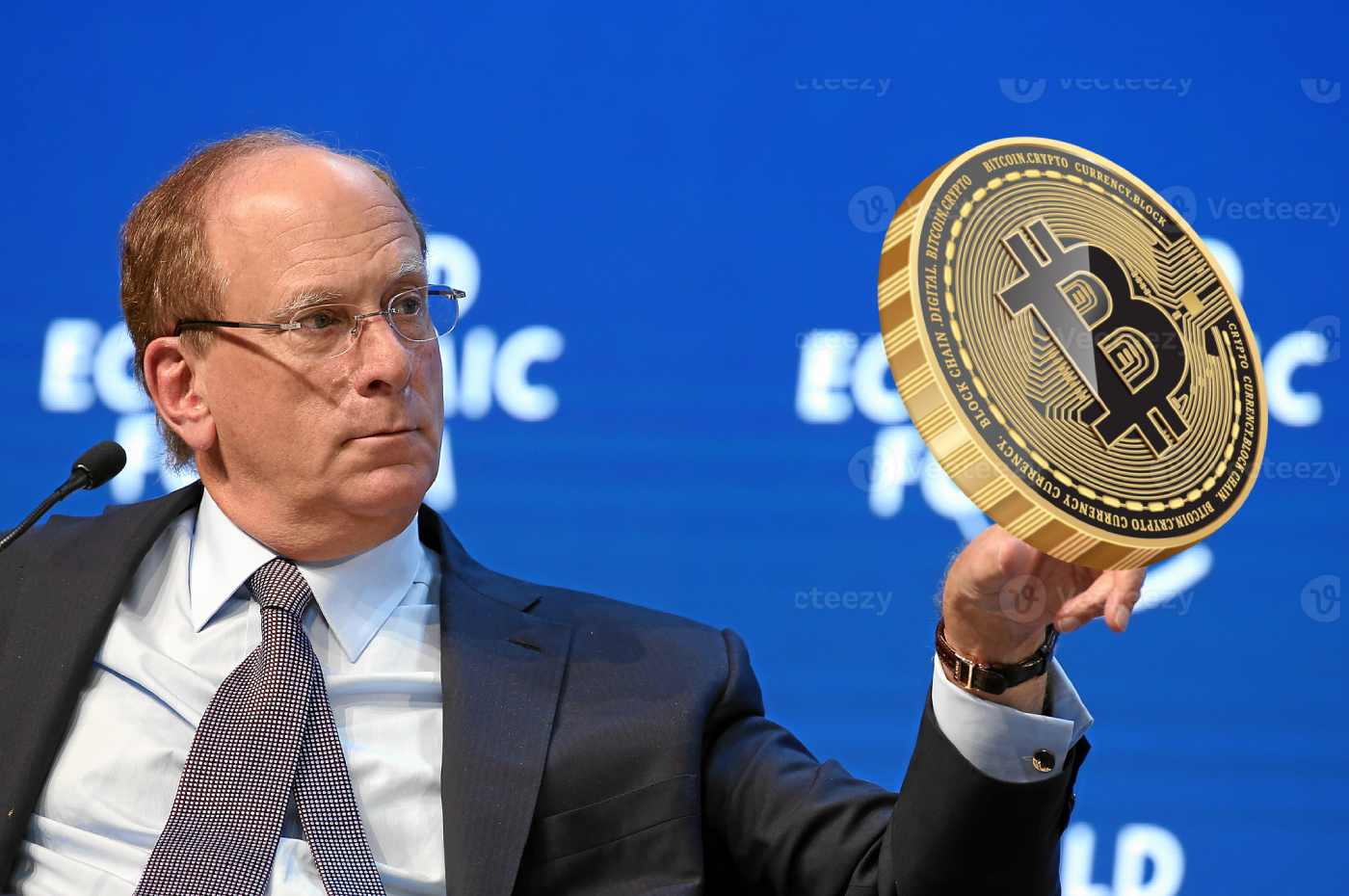 larry fink, ceo blackrock, trzymający monetę bitcoin