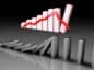 Domino symbolizujące początek krachu, w tle wykres spadku.