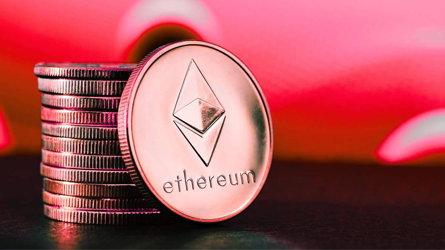 Monety Ethereum na czerwonym tle.