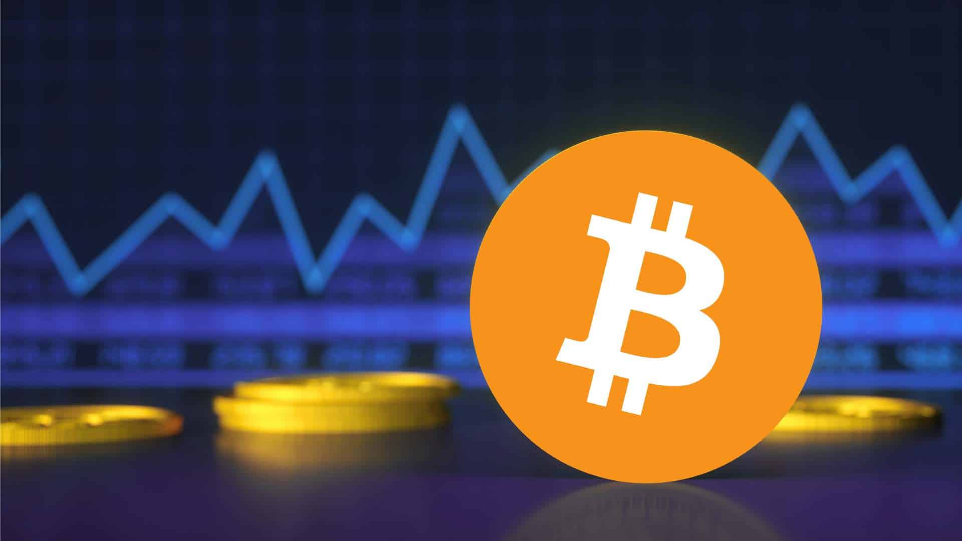 Logo Bitcoina na tle monet i wykresu giełodwego.