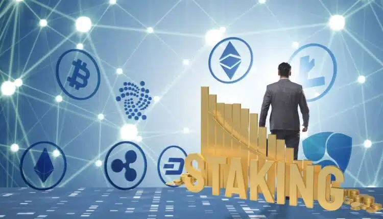 kryptowaluty na niebieskim tle, w prawym rogu człowiek w garniturze odwrócony tyłem, oraz wykres z napisem STAKING