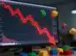 Kurs akcji Roblox na monitorze, spadający czerwony wykres, w tle klocki lego