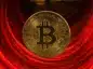 Bitcoin na tle czerwonej przepaści.